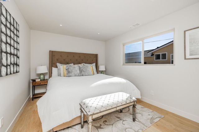 a bedroom with a bed and a chair