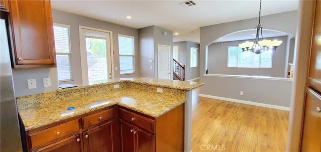 a bathroom with a granite countertop sink and a bathtub