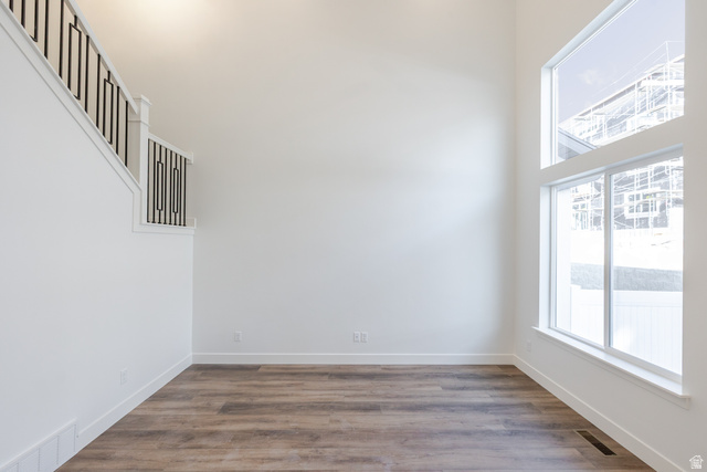 4775 Olive Avenue, Unit 412 Mapleton, UT 84664 - Photo 10 of 19 Unfurnished room featuring dark wood finished floors and a high ceiling