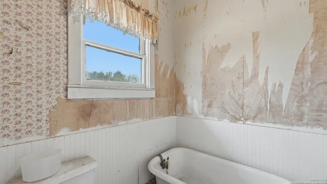 a bedroom with a bed and ceiling fan