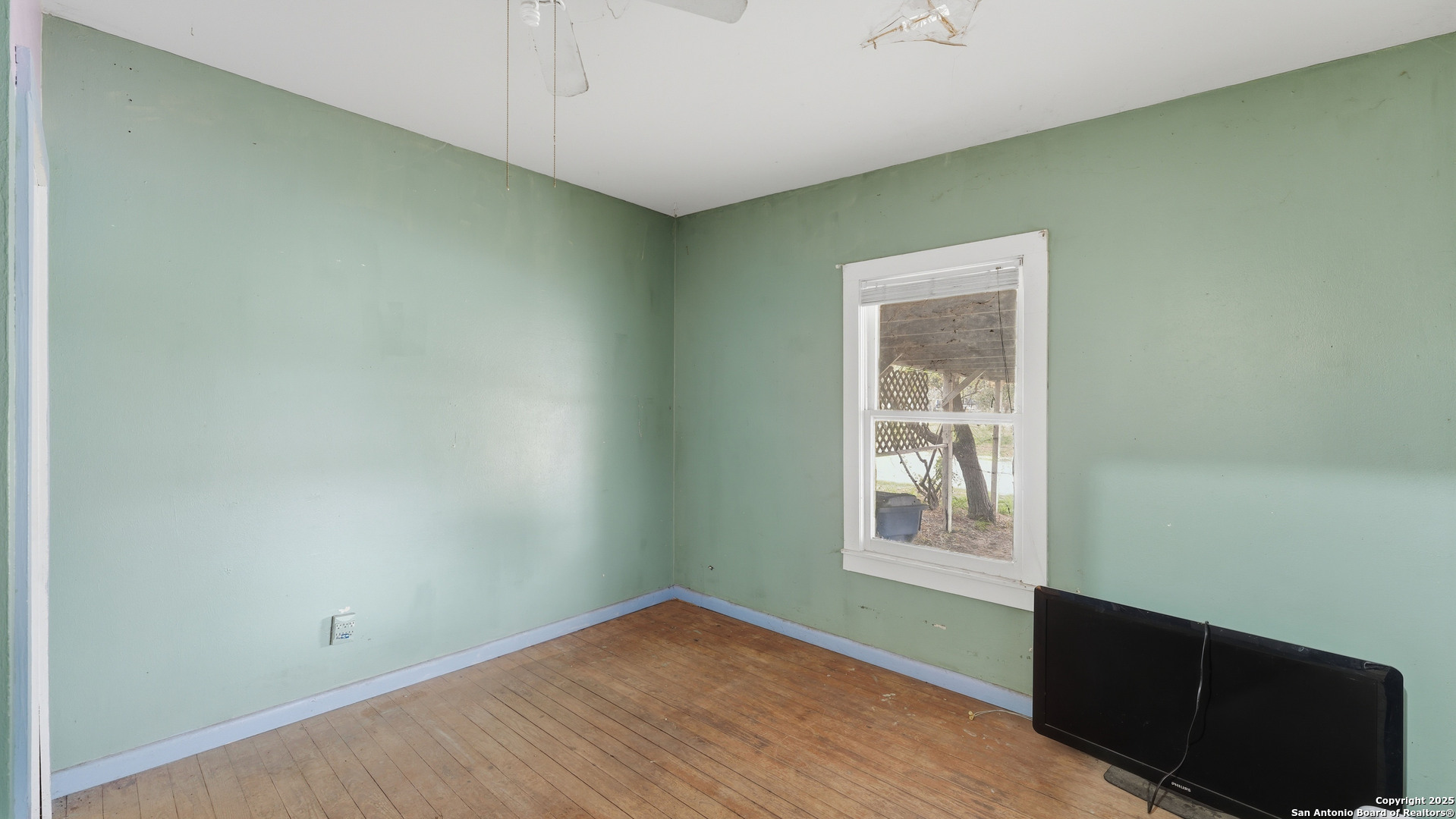 536 Commerce Street Pleasanton, TX 78064 - Photo 20 of 31 a view of a big room with wooden floor and windows
