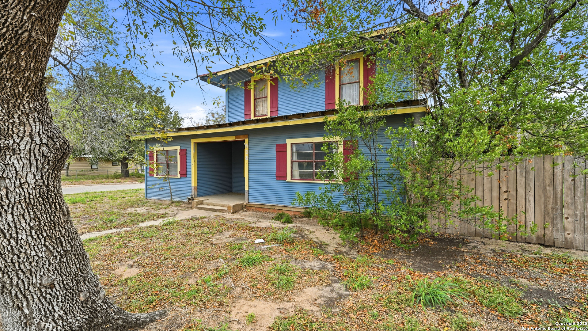 536 Commerce Street Pleasanton, TX 78064 - Photo 2 of 31 a view of a yard in front of a house with large tree