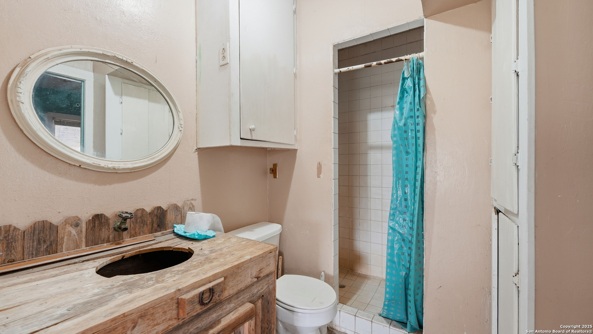 536 Commerce Street Pleasanton, TX 78064 - Photo 21 of 31 a bathroom with a toilet a sink and a mirror