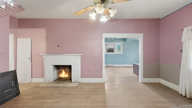 a view of an empty room with a fireplace