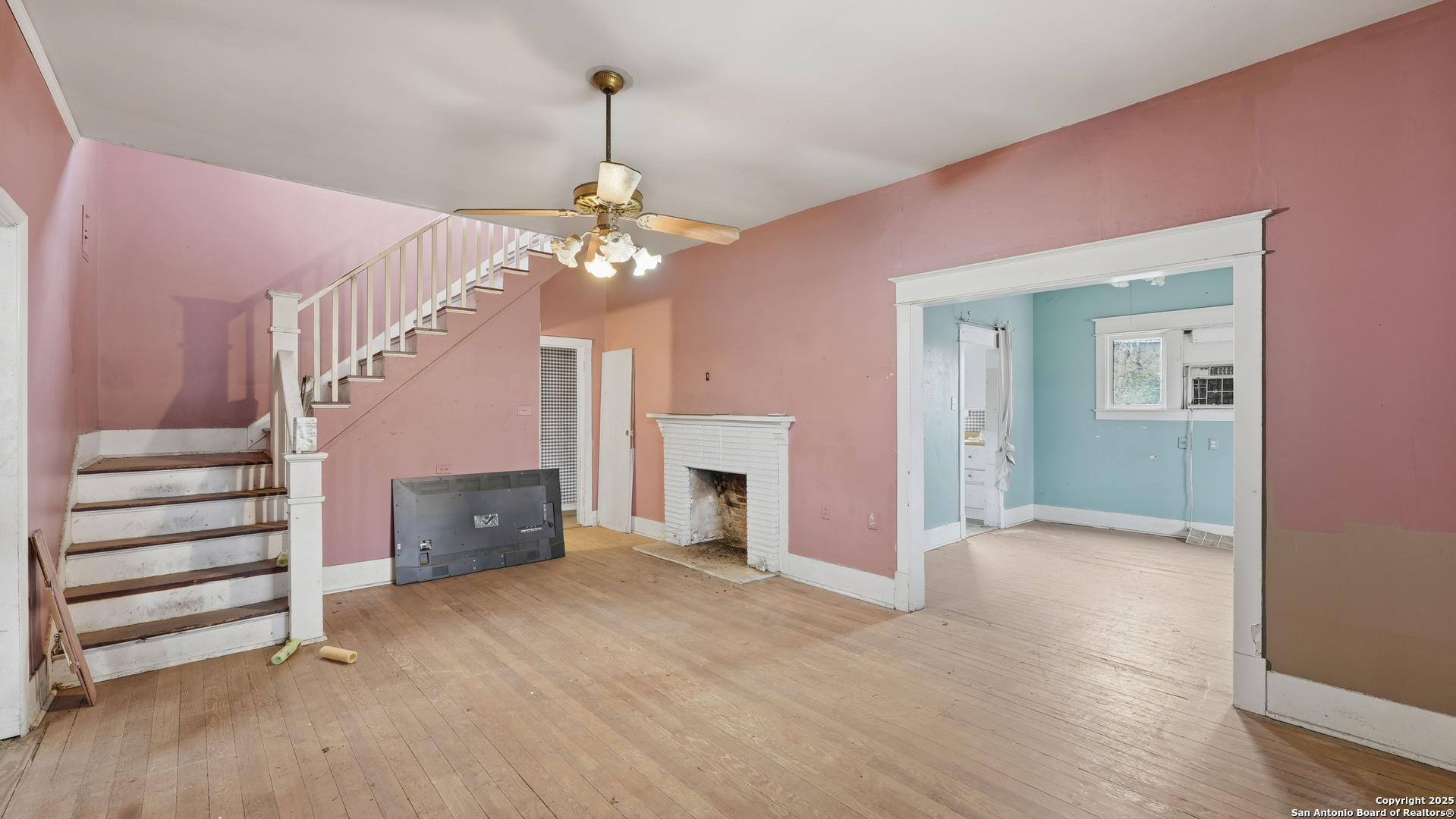 536 Commerce Street Pleasanton, TX 78064 - Photo 5 of 31 a view of a livingroom with a fireplace a chandelier and stairs