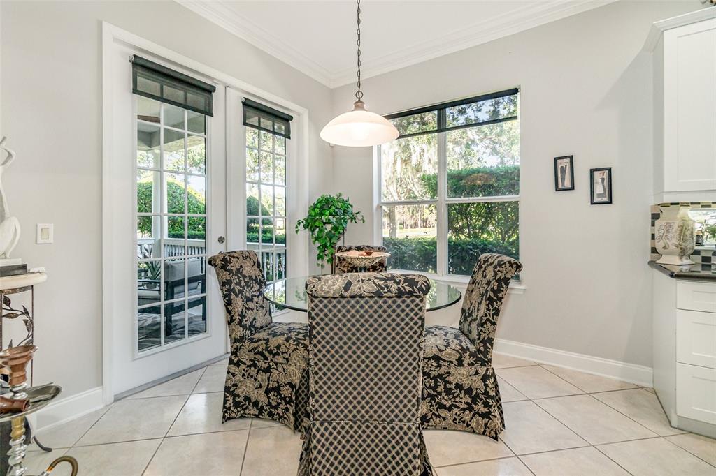 6905 Nobleton Drive Windermere, FL 34786 - Photo 17 of 41 a dining room with furniture a chandelier and window