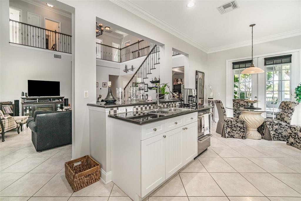 6905 Nobleton Drive Windermere, FL 34786 - Photo 19 of 41 a spacious bathroom with a granite countertop sink a mirror and a bathtub