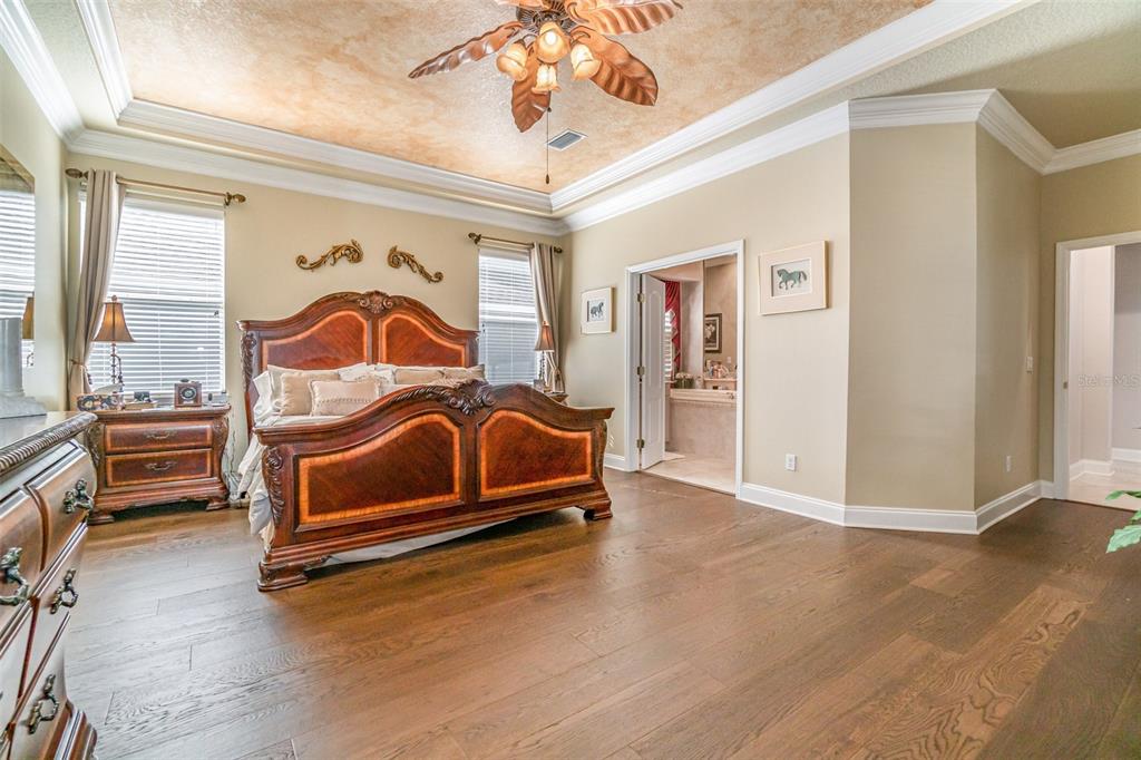 6905 Nobleton Drive Windermere, FL 34786 - Photo 24 of 41 a bedroom with bed and a chandelier