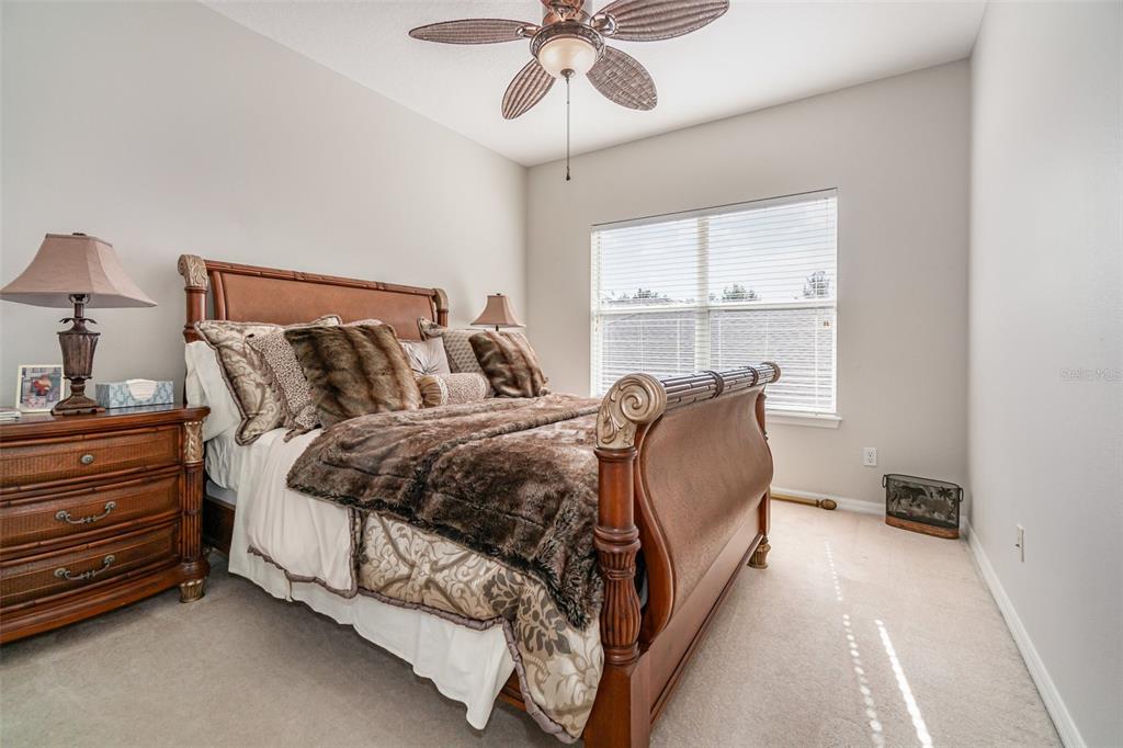 6905 Nobleton Drive Windermere, FL 34786 - Photo 30 of 41 a bed room with a bed and a chandelier