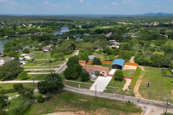 an aerial view of residential houses with outdoor space and river