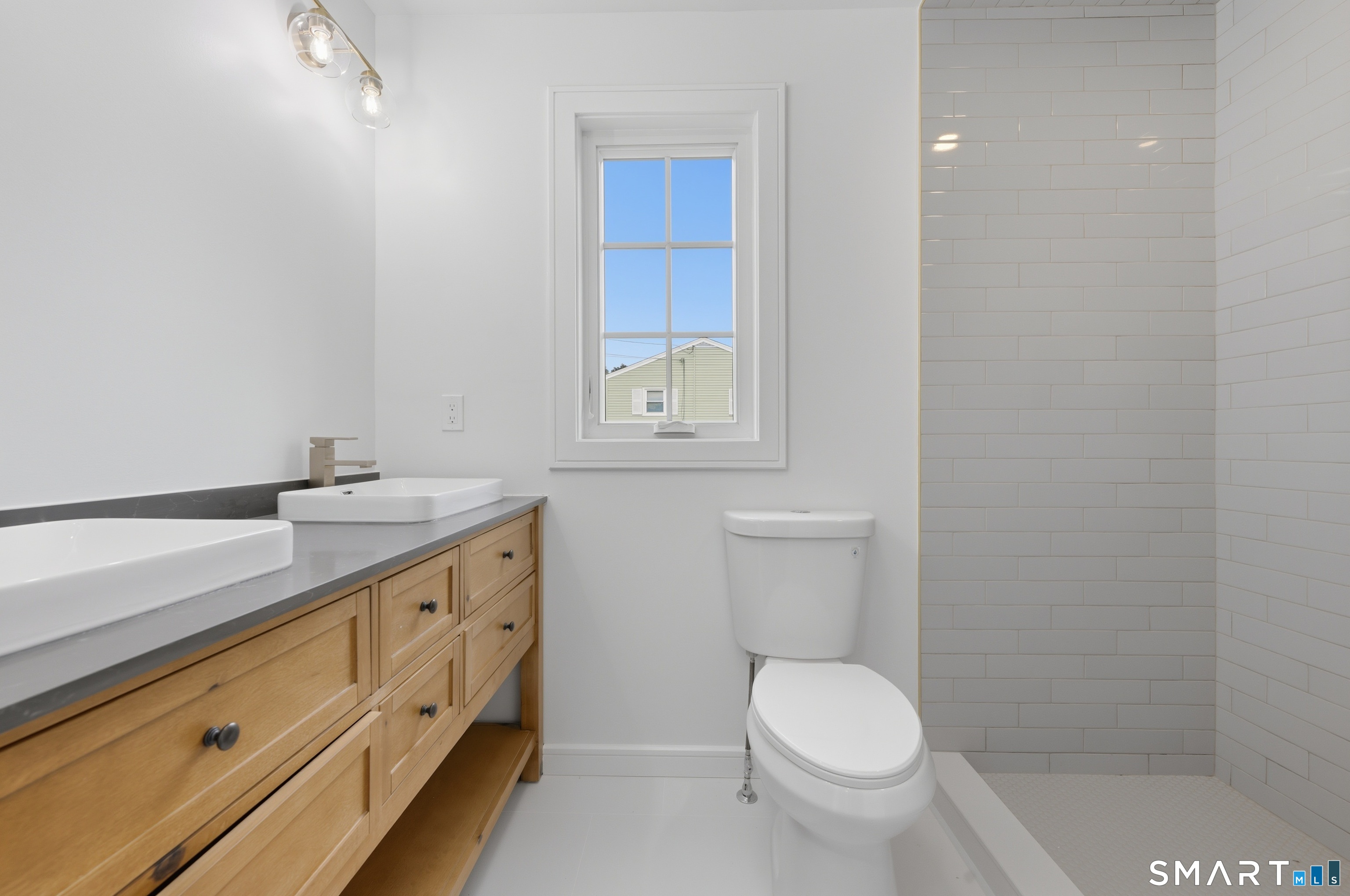 110 Russell Road Stratford, CT 06614 - Photo 17 of 31 a bathroom with a granite countertop toilet sink and mirror