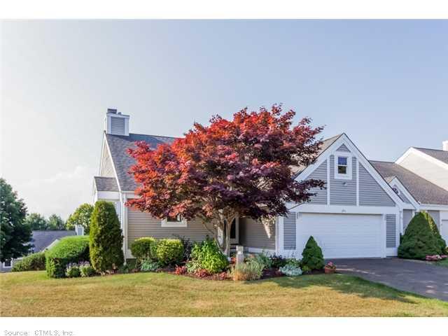291 Legend Hill Road, Unit 291 Madison, CT 06443 - Photo 1 of 1 a front view of a house with a garden