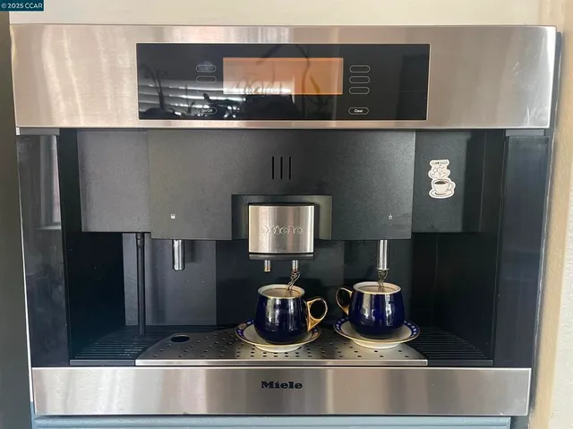 a kitchen with a refrigerator and a stove