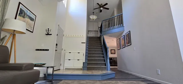 a view of entryway and hall with wooden floor