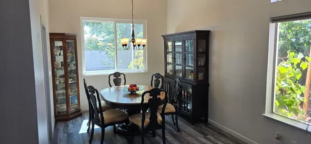 a view of a dining room with furniture and a window