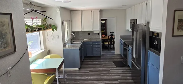 a dining room with furniture and a window