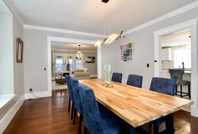 a dining room with furniture and wooden floor