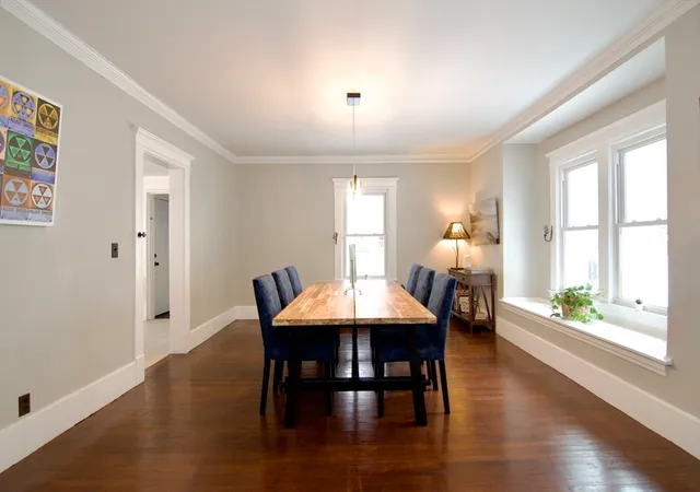 a dining room with furniture and wooden floor