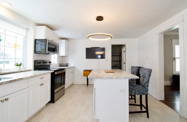 a kitchen with a table chairs stove and microwave