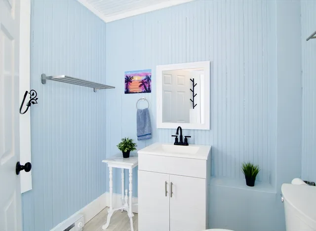 a bathroom with a sink a toilet and mirror