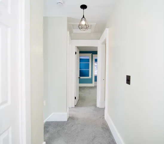 a view of a hallway with windows