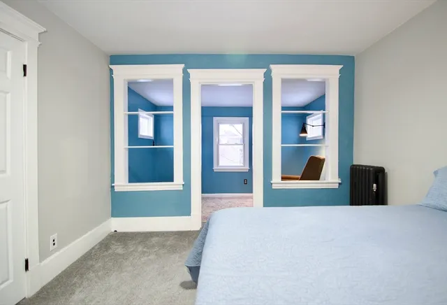 a bedroom with a bed and glass door