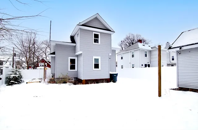 a view of a house with snow on the road