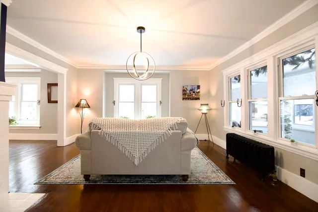 a living room with couches and wooden floor