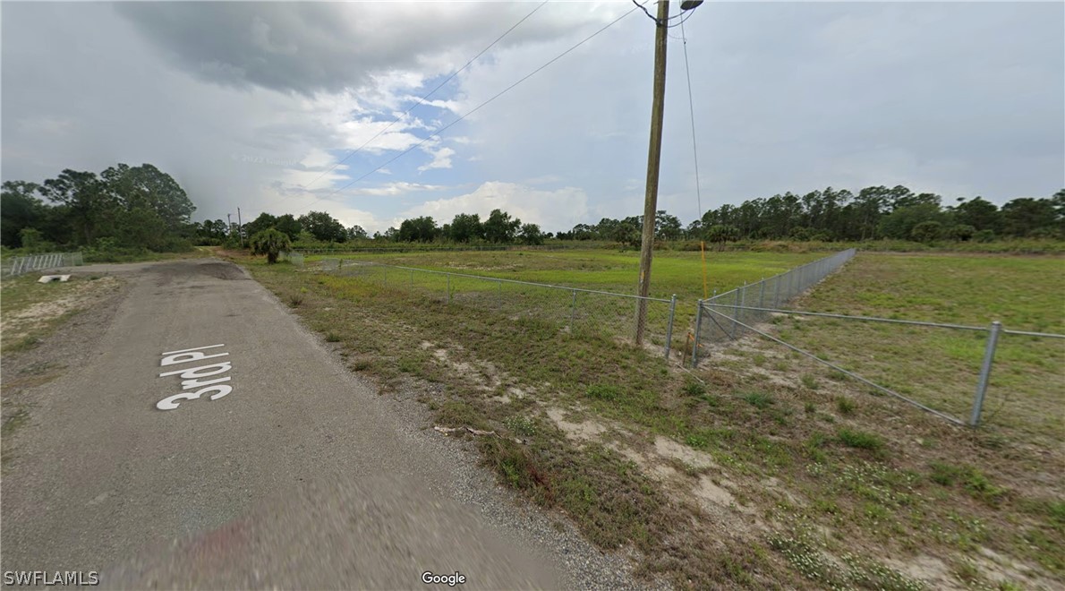 7537 3rd Place LaBelle, FL 33935 - Photo 4 of 9 a view of a street with a big yard