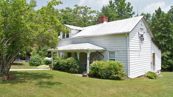 360 Kay Fork Road Union Hall, VA 24176 - Photo 3 of 6 a view of a white house with a yard and potted plants