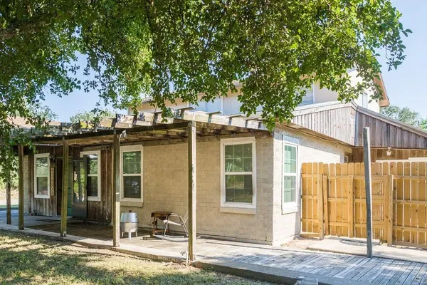 a front view of a house with a tree