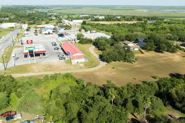 an aerial view of residential houses with outdoor space and swimming pool