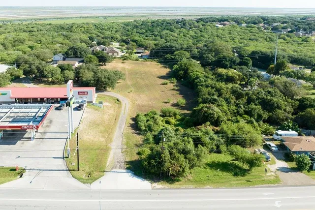 an aerial view of a house with a yard and lake view