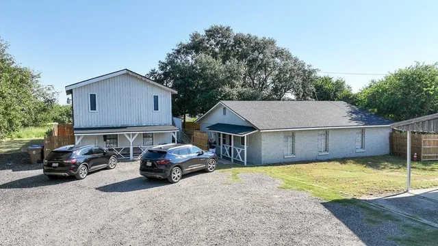 a car parked in front of house with a yard