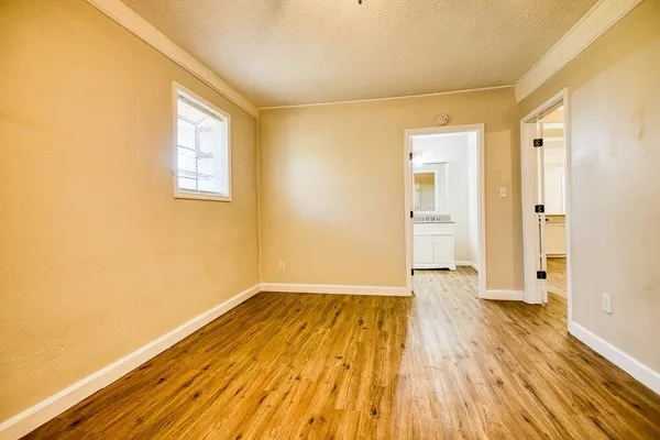 a view of a room with wooden floor and a window