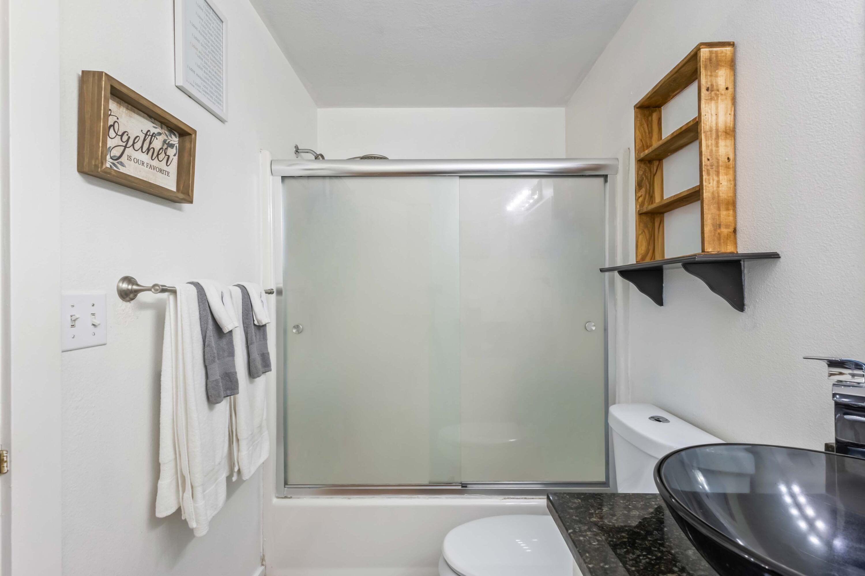 405 East D Street Culver, OR 97734 - Photo 17 of 49 a bathroom with a granite countertop shower and a toilet