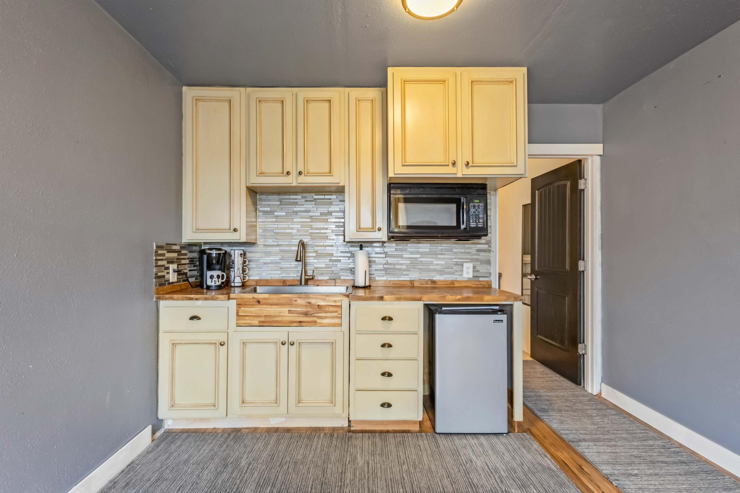 405 East D Street Culver, OR 97734 - Photo 27 of 49 a kitchen with stainless steel appliances a stove microwave and cabinets