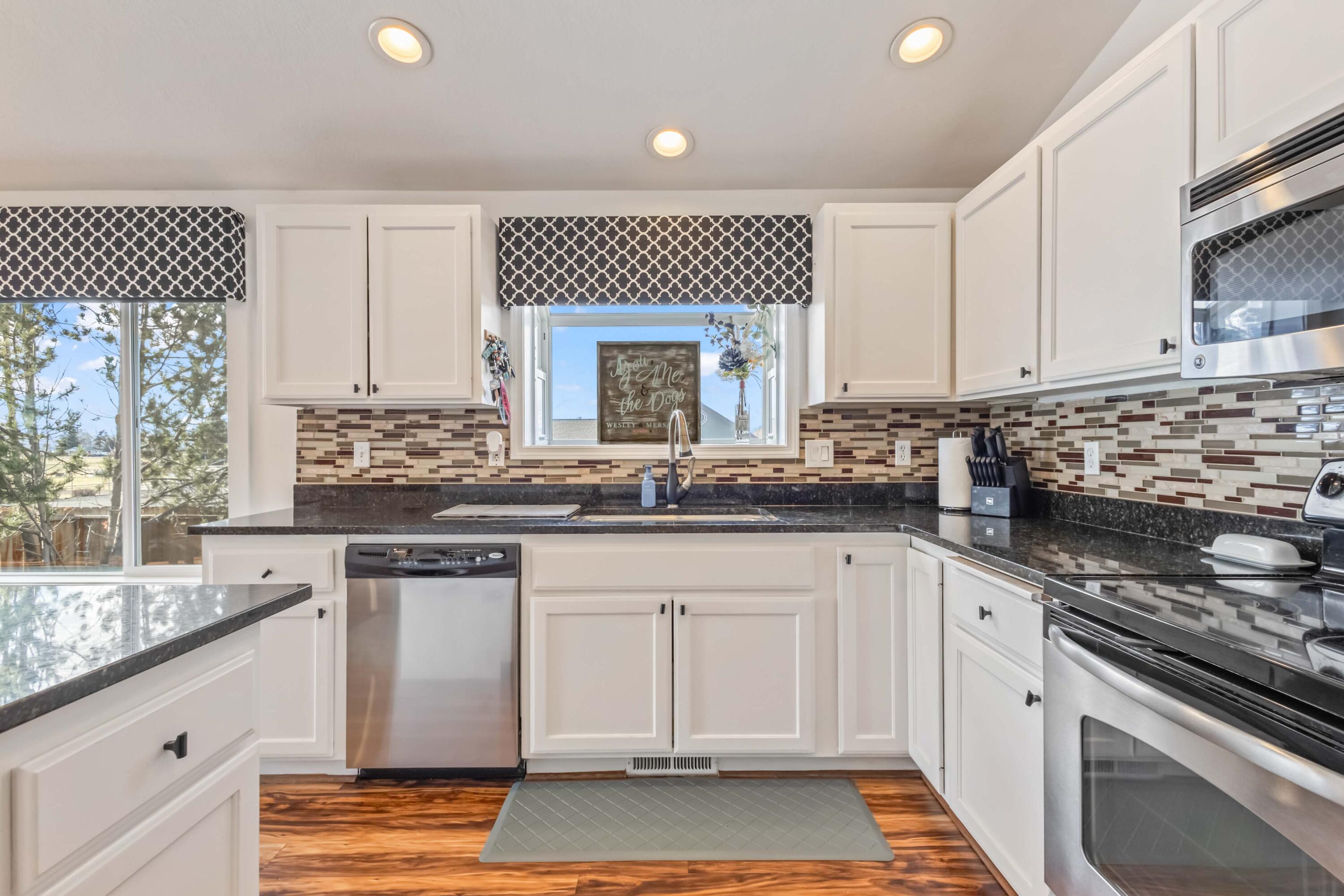 405 East D Street Culver, OR 97734 - Photo 8 of 49 a kitchen with granite countertop white cabinets and white appliances