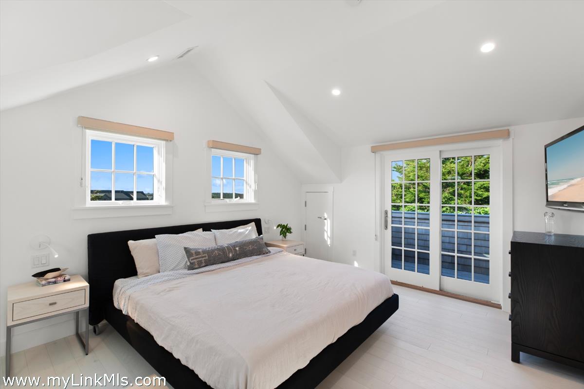 3 Tautemo Way Nantucket, MA 02554 - Photo 49 of 57 a bedroom with a bed and wooden floor