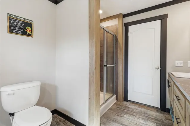 a bathroom with a toilet and a shower