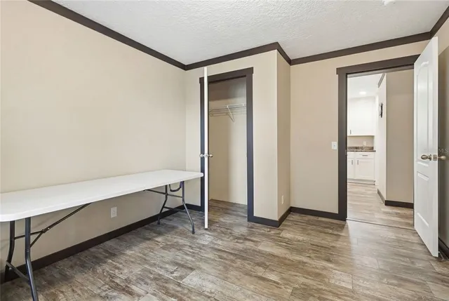 a view of room with wooden floor and windows
