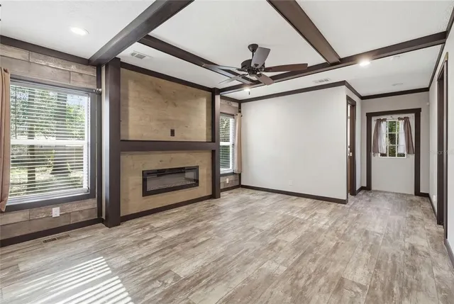 a view of a livingroom with a fireplace wooden floor and door