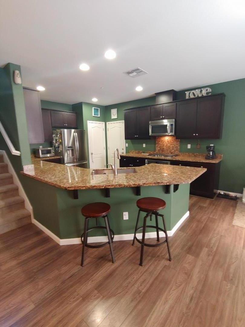 100 Caspian Way Gilroy, CA 95020 - Photo 2 of 7 a living room with furniture a wooden floor and next to a window
