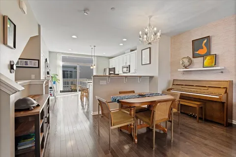 a view of a dining room with furniture wooden floor and chandelier