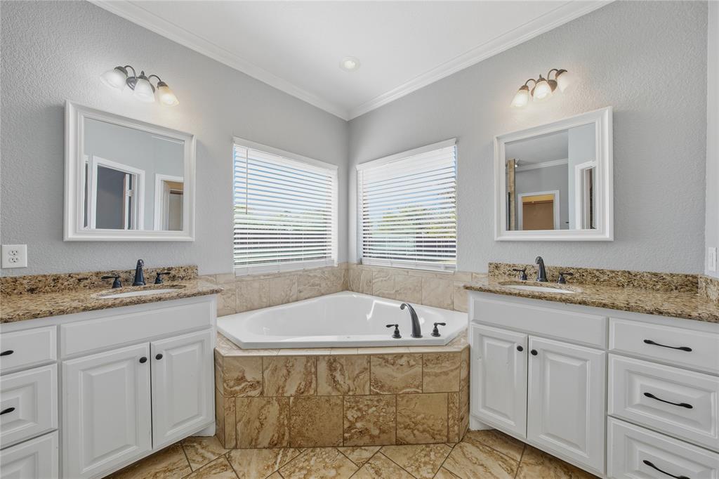 17821 Fm 3080 Mabank, TX 75147 - Photo 15 of 23 a spacious bathroom with sinks mirror and a bathtub
