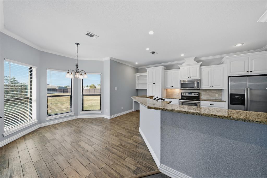 17821 Fm 3080 Mabank, TX 75147 - Photo 8 of 23 a large kitchen with stainless steel appliances granite countertop a refrigerator a stove a sink and a oven with wooden floors