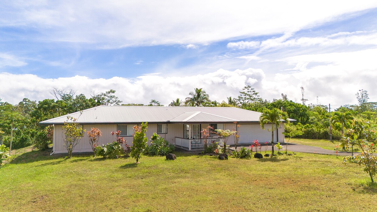 a yellow house with swimming pool in front of it