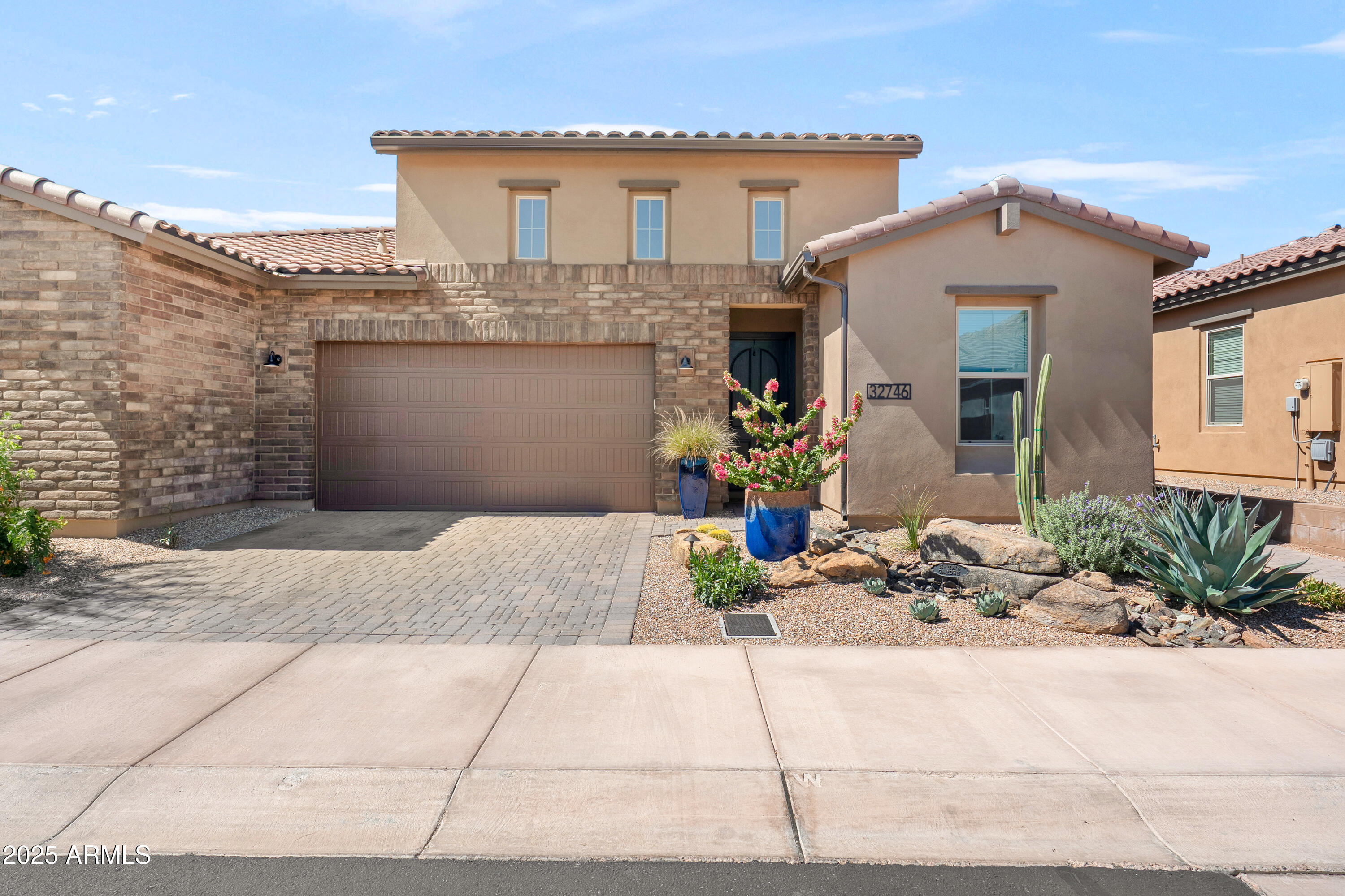 a front view of a house with plants
