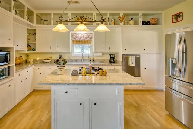 a spacious bedroom with a bed and a dresser