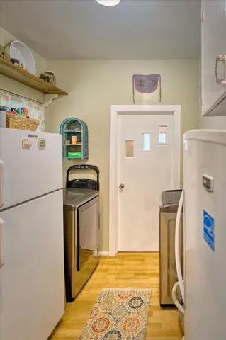 a spacious bedroom with a bed and a dresser